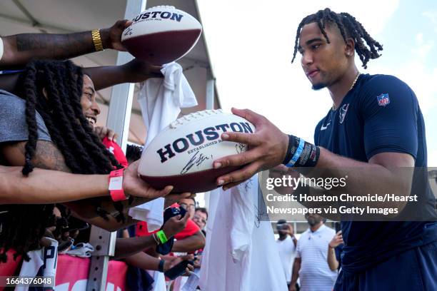 Houston Texans quarterback C.J. Stroud signs autographs at the end of practice during an NFL training camp Friday, July 28 in Houston.