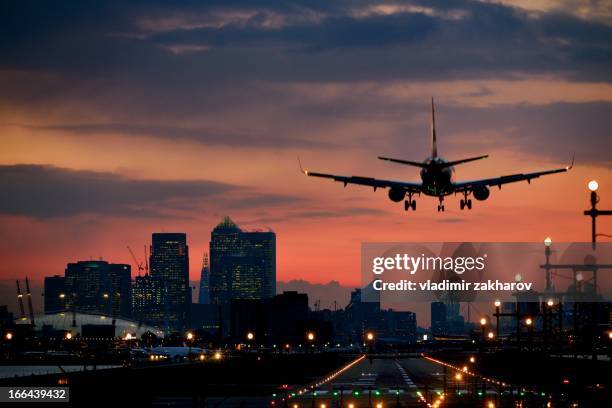 landing airplane at dusk - atterrir photos et images de collection