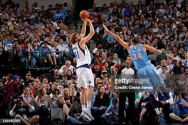 Dirk Nowitzki of the Dallas Mavericks shoots against JaVale McGee of the Denver Nuggets on April 12, 2013 at the American Airlines Center in Dallas,...