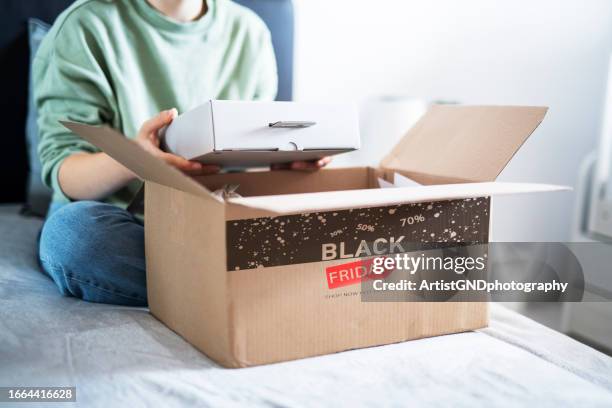 opening box with black friday sign. - black friday bildbanksfoton och bilder