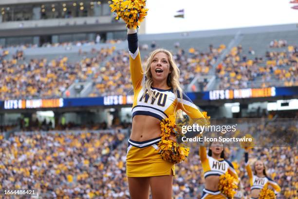 West Virginia Mountaineers cheerleader on the field during the first quarter of the college football game between the Duquesne Dukes and the West...