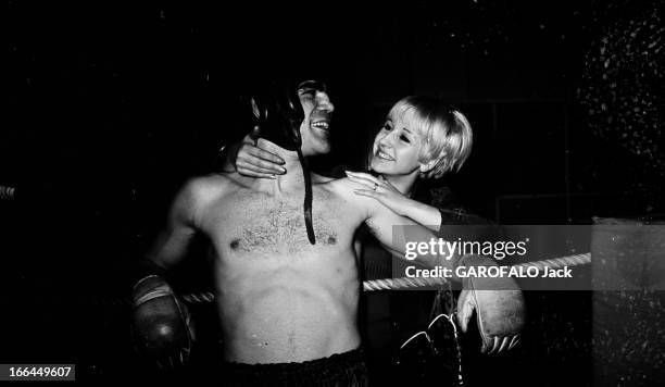 Rendezvous With Jacques Marty And His Wife. En 1966, sur le ring d'une salle de boxe, portrait du boxeur Jacques MARTY torse nu un casque sur la tête...