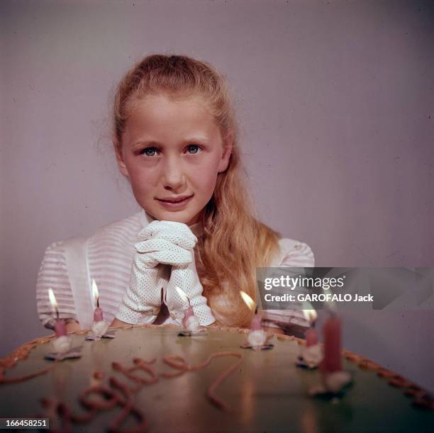 Brigitte Fossey Poses In Studio. Semur-en-Auxois - juin 1956 - A l'occasion de ses dix ans, vêtue d'une robe blanche et de gants blancs, les cheveux...