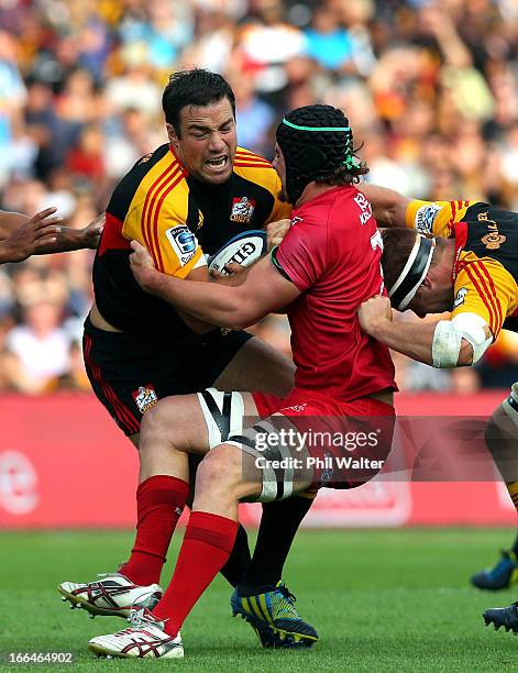 Richard Kahui of the Chiefs is tackled by Liam Gill of the Red during the round nine Super Rugby match between the Chiefs and the Reds at Waikato...