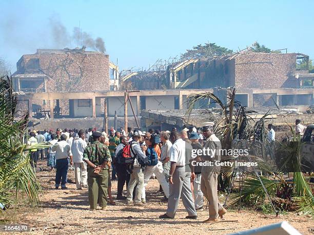 People stand outside the Paradise Hotel after it was attacked by suicide bombers November 28, 2002 in Mombasa, Kenya. At least 13 people were killed...