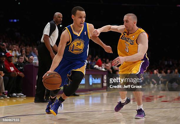 Stephen Curry of the Golden State Warriors drives around Steve Blake of the Los Angeles Lakers in the second half at Staples Center on April 12, 2013...