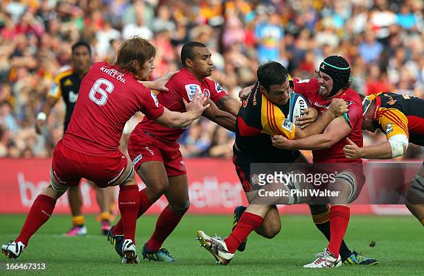 Richard Kahui of the Chiefs is tackled by Liam Gill of the Red during the round nine Super Rugby match between the Chiefs and the Reds at Waikato...