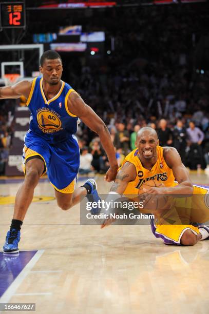 Kobe Bryant of the Los Angeles Lakers gets injured while driving against Harrison Barnes of the Golden State Warriors at Staples Center on April 12,...