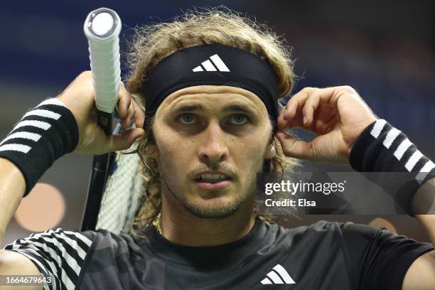 Alexander Zverev of Germany adjusts his headband against Carlos Alcaraz of Spain during their Men's Singles Quarterfinal match on Day Ten of the 2023...