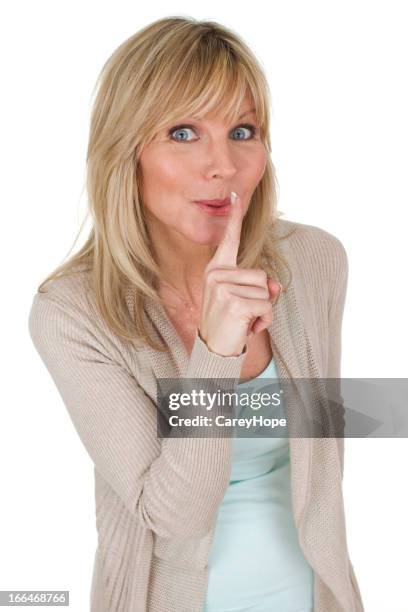 woman hushing - woman with finger on lips stock pictures, royalty-free photos & images