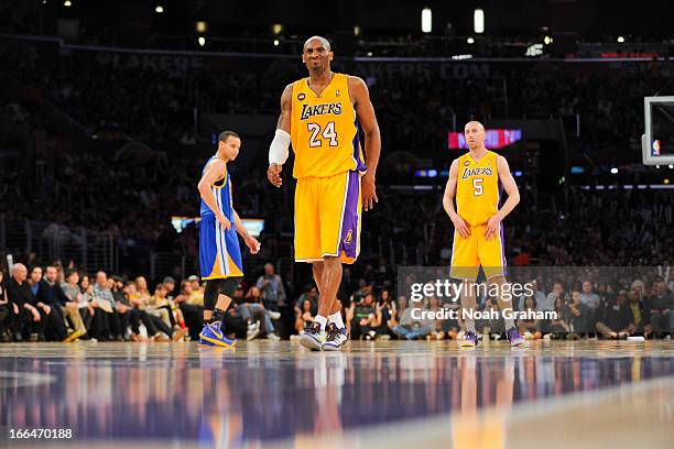 Kobe Bryant of the Los Angeles Lakers winces before shooting a free-throw during a game against the Golden State Warriors at Staples Center on April...