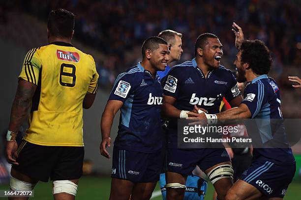 Charles Piutau of the Blues celebrates after scoring a try with Peter Saili and Rene Ranger during the round nine Super Rugby match between the Blues...