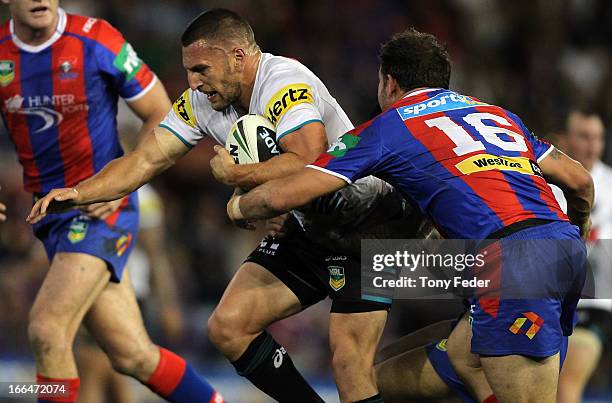 Lewis Brown of the Panthers is tackled by Knights defence during the round six NRL match between the Newcastle Knights and the Penrith Panthers at...