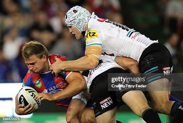 Robbie Rochow of the Knights is tackled by the Panthers defence during the round six NRL match between the Newcastle Knights and the Penrith Panthers...