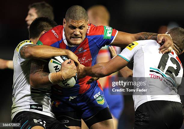 Willie Mason of the Knights is tackled by the Panthers defence during the round six NRL match between the Newcastle Knights and the Penrith Panthers...