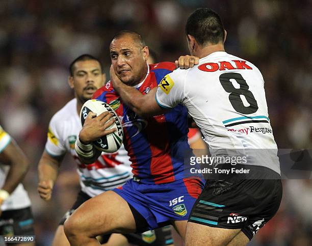 Jeremy Smith of the Knights is tackled by Panthers defence during the round six NRL match between the Newcastle Knights and the Penrith Panthers at...