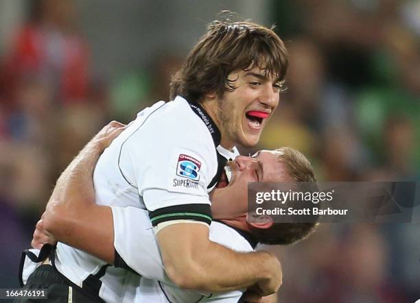 Demetri Catrakilis of the Kings is embraced by his teamates after kicking the winning drop goal during the round nine Super Rugby match between the...