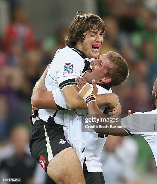 Demetri Catrakilis of the Kings is embraced by his teamates after kicking the winning drop goal during the round nine Super Rugby match between the...