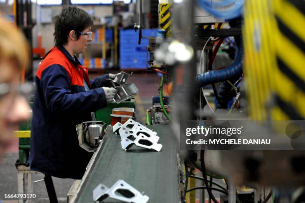 An employee works on the production line of a factory of the European car parts maker, British Wagon automotives, on January 22, 2009 in Orbec,...