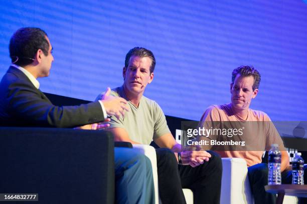 Cameron Winklevoss, co-founder and president of Gemini Trust Co., center, with his brother Tyler Winklevoss, co-founder and chief executive officer,...