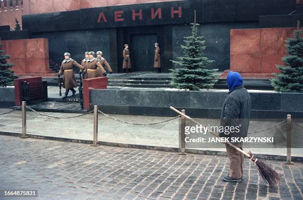 Municipal employee looks at the changing of the guard in front of the Lenin Mausoleum at the Moscow Red Square on December 26, 1991. The Soviet Union...