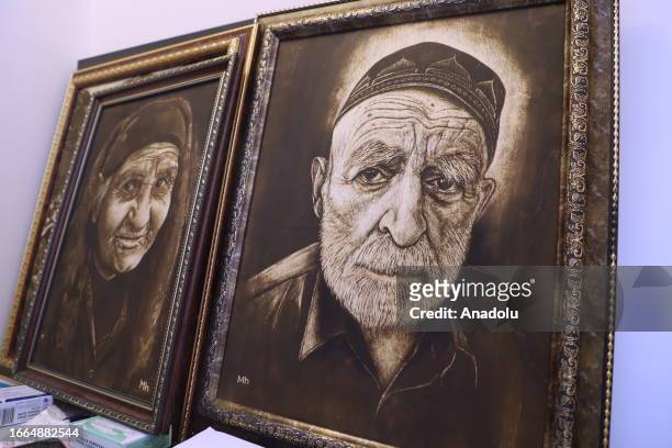 View of the drawings by 71 year-old Azerbaijani amateur painter Huseyin Mirtegevi using the medical scalpels on colored wooden boards in Baku,...