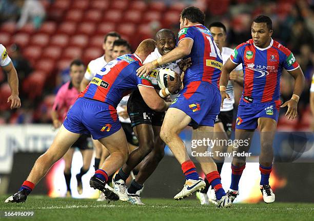 Wes Naiqama of the Panthers is tackled by the Knights defence during the round six NRL match between the Newcastle Knights and the Penrith Panthers...