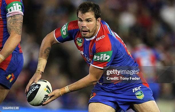 Adam Cuthbertson of the Knights passes the ball during the round six NRL between the Newcastle Knights and the Penrith Panthers at Hunter Stadium on...