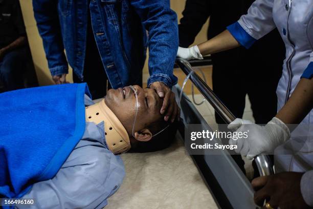 Injured passenger Ketut Manis from the Lion Air passenger plane crash receives medical treatment at hospital on April 13, 2013 in Kedonganan, Bali,...