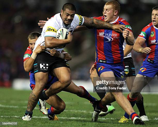 Sika Manu of the Panthers is tackled by Alex McKinnon of the Knights during the round six NRL match between the Newcastle Knights and the Penrith...