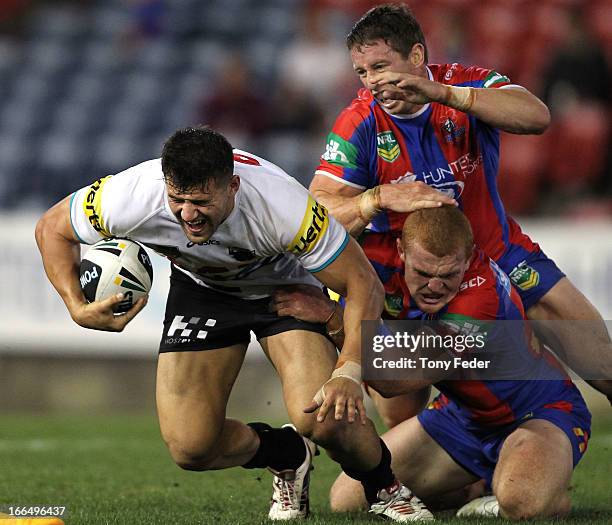 Josh Mansour of the Panthers is tackled by Alex McKinnon of the Knights during the round six NRL match between the Newcastle Knights and the Penrith...