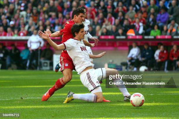 Mario Gomez of Muenchen scores the second team goal against Timm Klose of Nuernberg during the Bundesliga match between FC Bayern Muenchen and 1. FC...