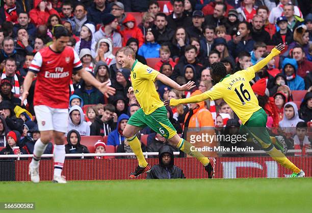 Michael Turner of Norwich City celebrates scoring the first goal of the match with teammate Kei Kamara during the Barclays Premier League match...
