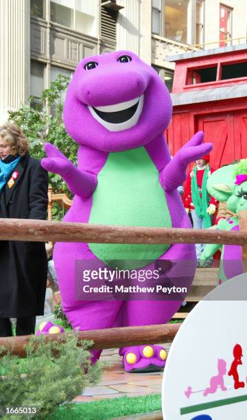 Barney the dinosaur rides on a float at the 76th Annual Macy's Thanksgiving Day Parade in Herald Square November 28, 2002 in New York City.