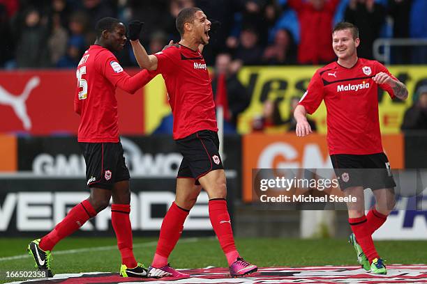 Rudy Gestede of Cardiff City celebrates scoring his teams third goal alongside Leon Barnett and Aron Gunnarsson during the npower Championship match...