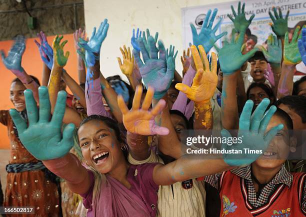 Street Children during their attempt of putting maximum handprints on white cloth in minimum time of 15 minutes in the famed Limca Book of Records'...