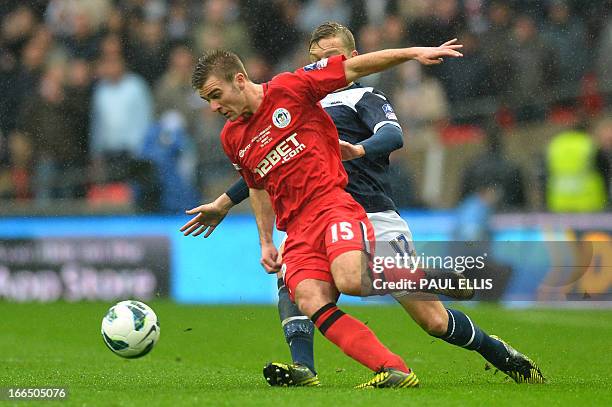 Millwall's Australian defender Shane Lowry vies with Wigan Athletic's English striker Callum McManaman during the FA Cup semi-final football match...