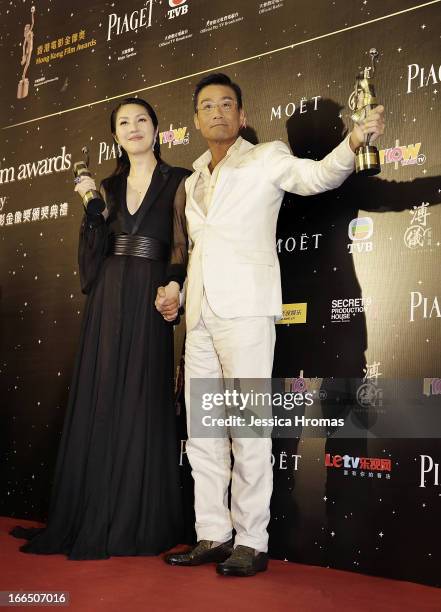 Tony Leung Ka Fai , winner of the award for Best Actor, and Miriam Yeung, winner of the award for Best Actress pose with their awards in the Awards...