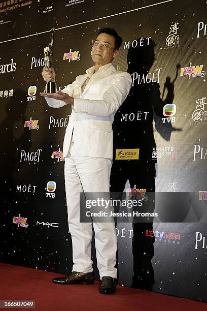 Tony Leung Ka Fai, winner of the award for Best Actor, poses with his award in the Awards Room at the 2013 Hong Kong Film Awards on April 13, 2013 in...