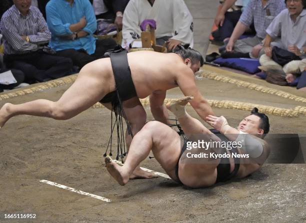 Ozeki Kirishima beats rank-and-filer Asanoyama on the fifth day of the 15-day Autumn Grand Sumo Tournament at Ryogoku Kokugikan in Tokyo on Sept. 14,...