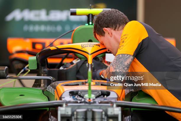 Mechanic works on the driving the McLaren MCL60 Mercedes of Lando Norris of Great Britain during previews ahead of the F1 Grand Prix of Singapore at...