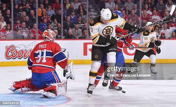 Milan Lucic of the Boston Bruins battles for position against Davis Drewiske in front of goaltender Carey Price of the Montreal Canadiens during the...