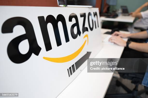 September 2023, Saxony, Dresden: An Amazon software developer sits at a desk during a press event at the online retailer's research and development...