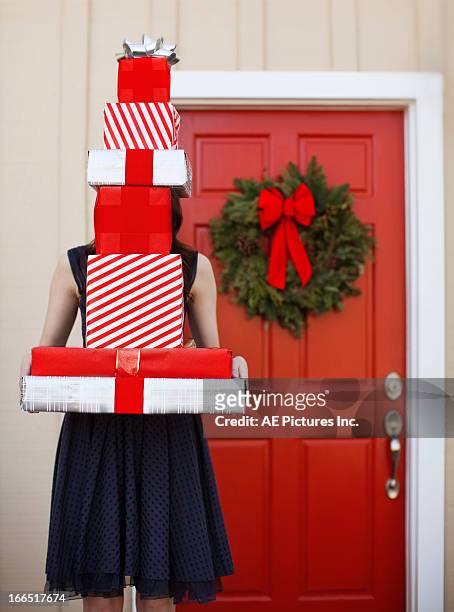 woman with stack of gifts - pile of gifts stock pictures, royalty-free photos & images