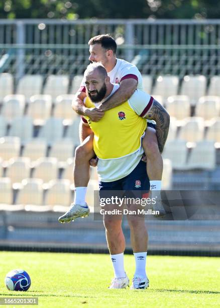 Joe Marler of England uses Danny Care of England to help stretch during a training session at Stade Ferdinand Petit on September 07, 2023 in Le...