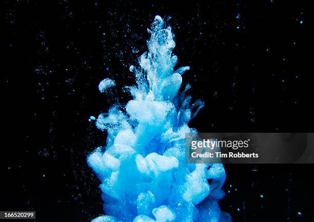 fountain of blue in water. - spreading stock pictures, royalty-free photos & images