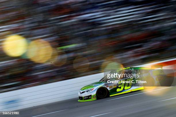 David Stremme, driver of the Lean 1/Swan Energy Toyota, races during the NASCAR Sprint Cup Series NRA 500 at Texas Motor Speedway on April 13, 2013...