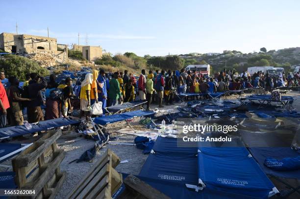 View of crowd outside of the hotspot as nearly 6,800 irregular migrants arrive in Lampedusa island of Italy on September 13, 2023. Located on the...