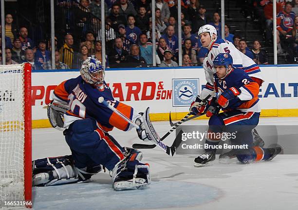 Dan Girardi of the New York Rangers scores the game winning goal at 3:11 of overtime against Evgeni Nabokov of the New York Islanders at the Nassau...