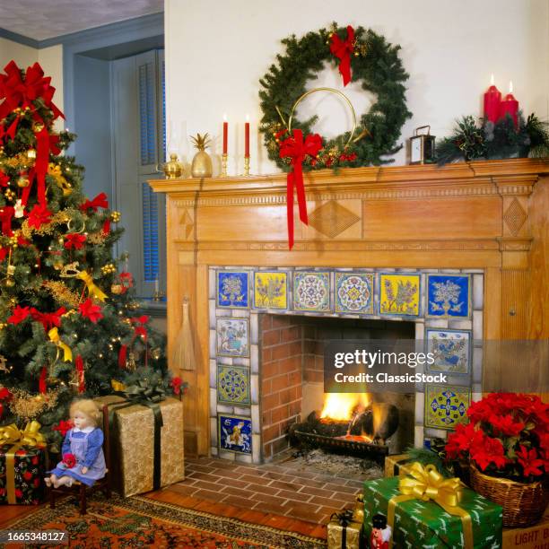 1980s Living room with wreath and candles above tiled fireplace christmas tree and wrapped presents.